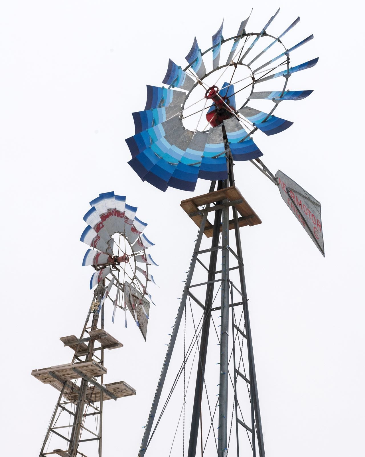 Restored windmills at Windmill Acres in Neola, Iowa. Mike Gibbs the proprietor of this Harvest Host site, locates these abandon machines, removes them to his property, finds parts and is able to reconstruct them to working condition. Beautiful sculpture on the landscape! #restoredwindmills #windmillacres #neolaiowa #mikegibbs #orcuttphotography #iowaphotography