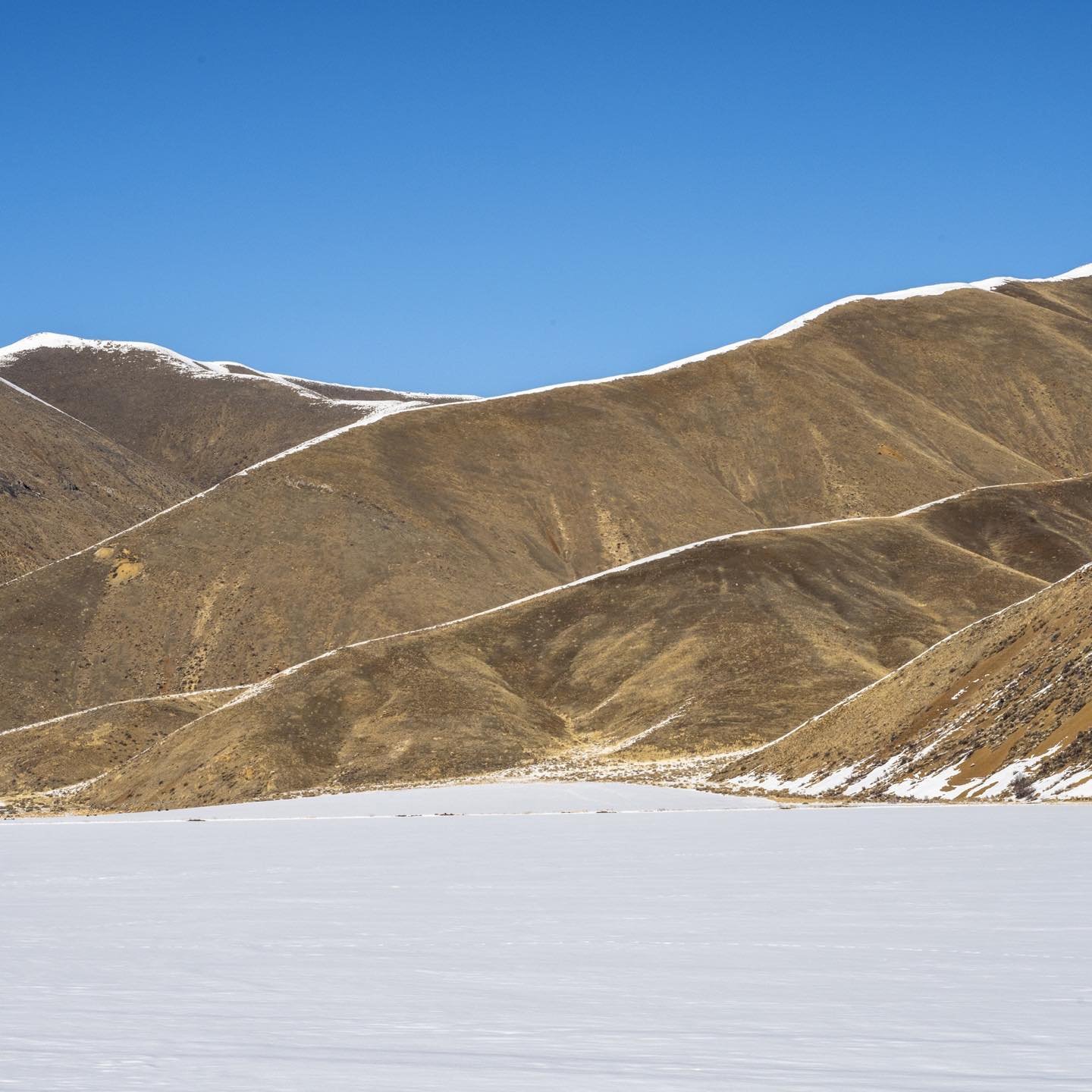 Snow traces on the south faces of mountain ridges near Gannett, Idaho last week created a strong graphic outline of the topography. #bestofthegemstate #orcuttphotography.danstpeter.com #triptosunvalley #gannettidaho #westernmountains #idahophotography #westernwinterphotography