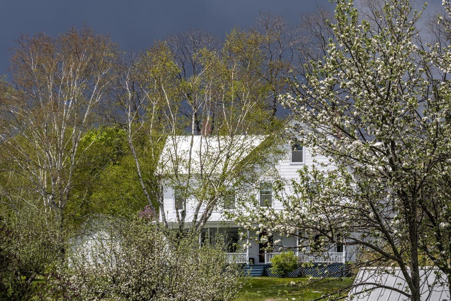 View from our Schoolhouse front porch looking north towards Hammond’s house. Living in the center of town, we have great village scenes in all directions. Photo by Cindy Orcutt. #kingfieldmaine #villagelife #orcuttphotography #springinmaine