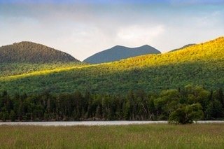 Low clouds directed spot lighting on the Bigelow Range in western Maine last evening. The flank of Cranberry Mountain is brightly contrasted with the Horns in shadow. As many times as I have photographed from the overlook location the scene is always different. #bigelowrangemaine #flagstafflakemaine #springlight #strattonandeustismaine #orcuttphotography.danstpeter.com #westernmaine #highpeaksofmaine