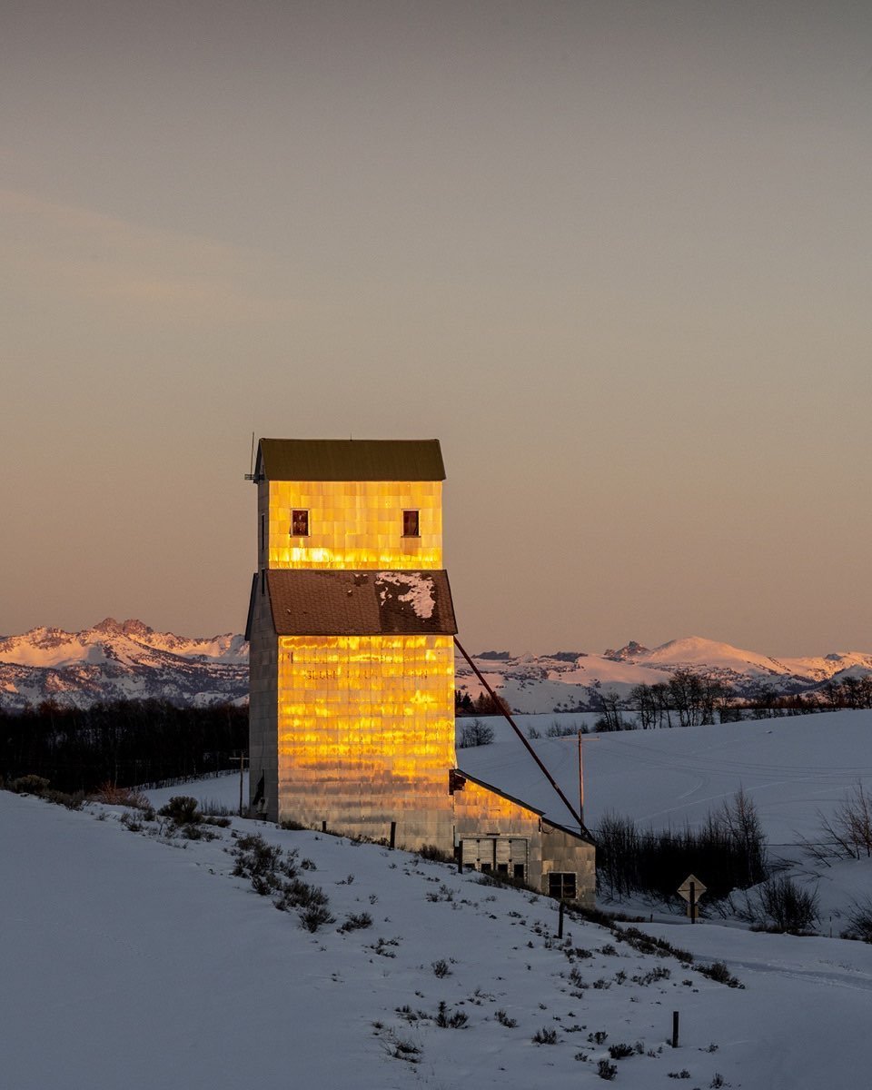 Historic Pillsbury Grain Elevator, between Felt and Ashton, Idaho. Like distant ships on the horizon, grain elevators in the American West appear in the wide-open landscape long before reaching them. Happening upon these magnificent structures, one thinks about the engineering, the transport of materials, the labor and perseverance that it must have taken to construct them.Frank Gohlke, master of the Texas landscape, expressed his feelings about these extraordinary buildings with these few sentences: “I was frustrated by the discrepancy between the ordinariness of the facts surrounding the grain elevators and the intensity of my emotional responses to the objects themselves. .... The dignity of grain elevators, the precision, intelligence and grace of their formal language, their majestic presence within the landscape all seem to confirm the faith that, given the right circumstances, we will make visible the best that is within us”. #orcuttphotography #bestofthegemstate #historicidahograinelevators