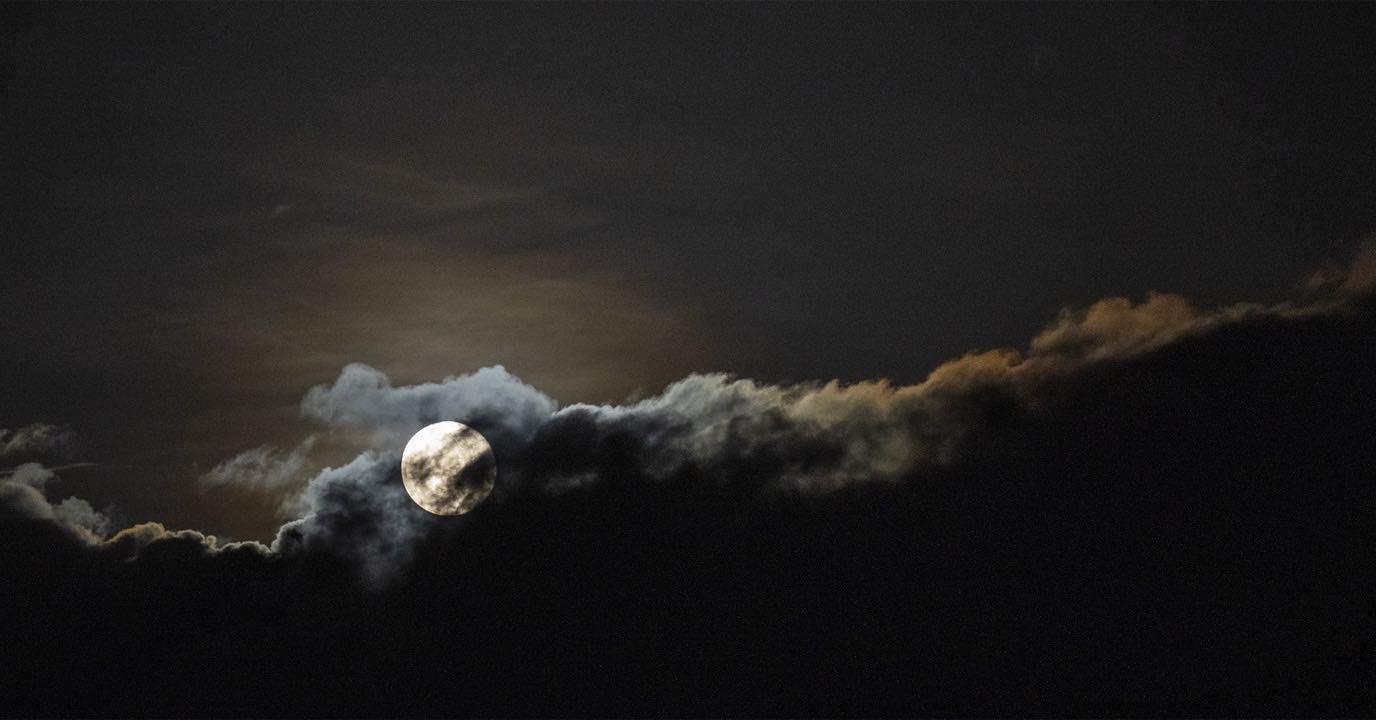 Full moon breaking through a cloud bank over the Teton Range. Photo by Cindy Orcutt from our back yard in Driggs, Idaho. #moonphotography #tetonrange #orcuttphotography #bestofthegemstate #driggsidaho