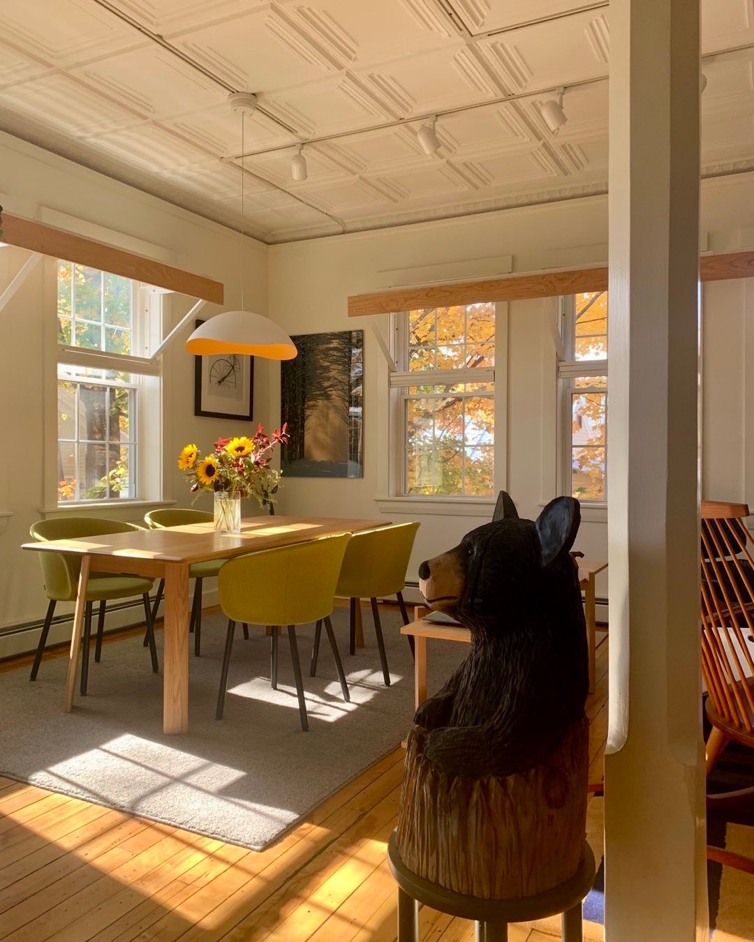 The interior of our Schoolhouse residence in Kingfield, Maine is made more comfortable by the presence of this little fellow. Carved by chainsaw artist, Brad Clark from North Anson, Maine, it greets us as we enter the open living room. #kingfieldmaine #bradclarkchainsawartist #blackbear #orcuttphotography #schoolhouseart
